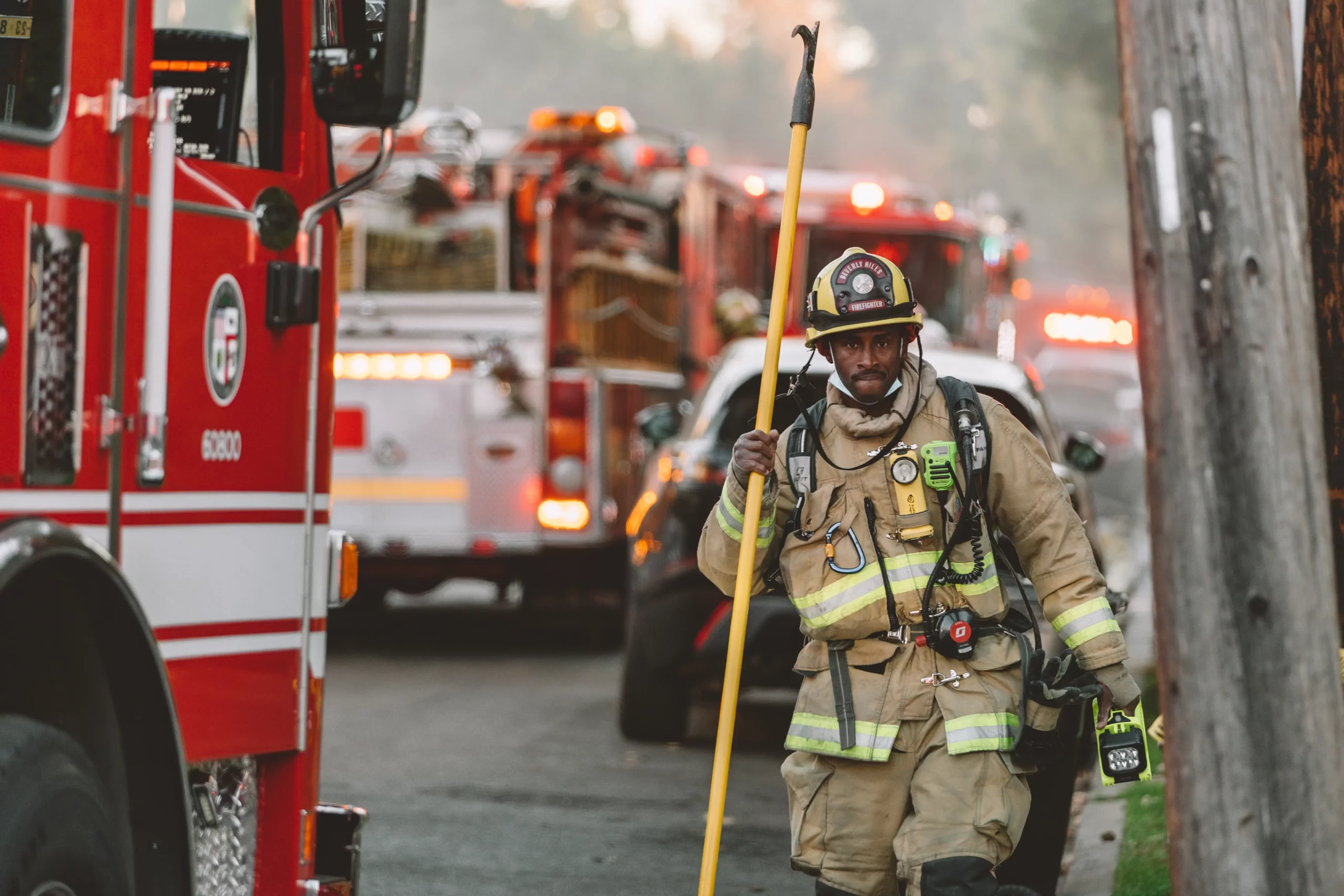 Firefighter walking with vehicles in background