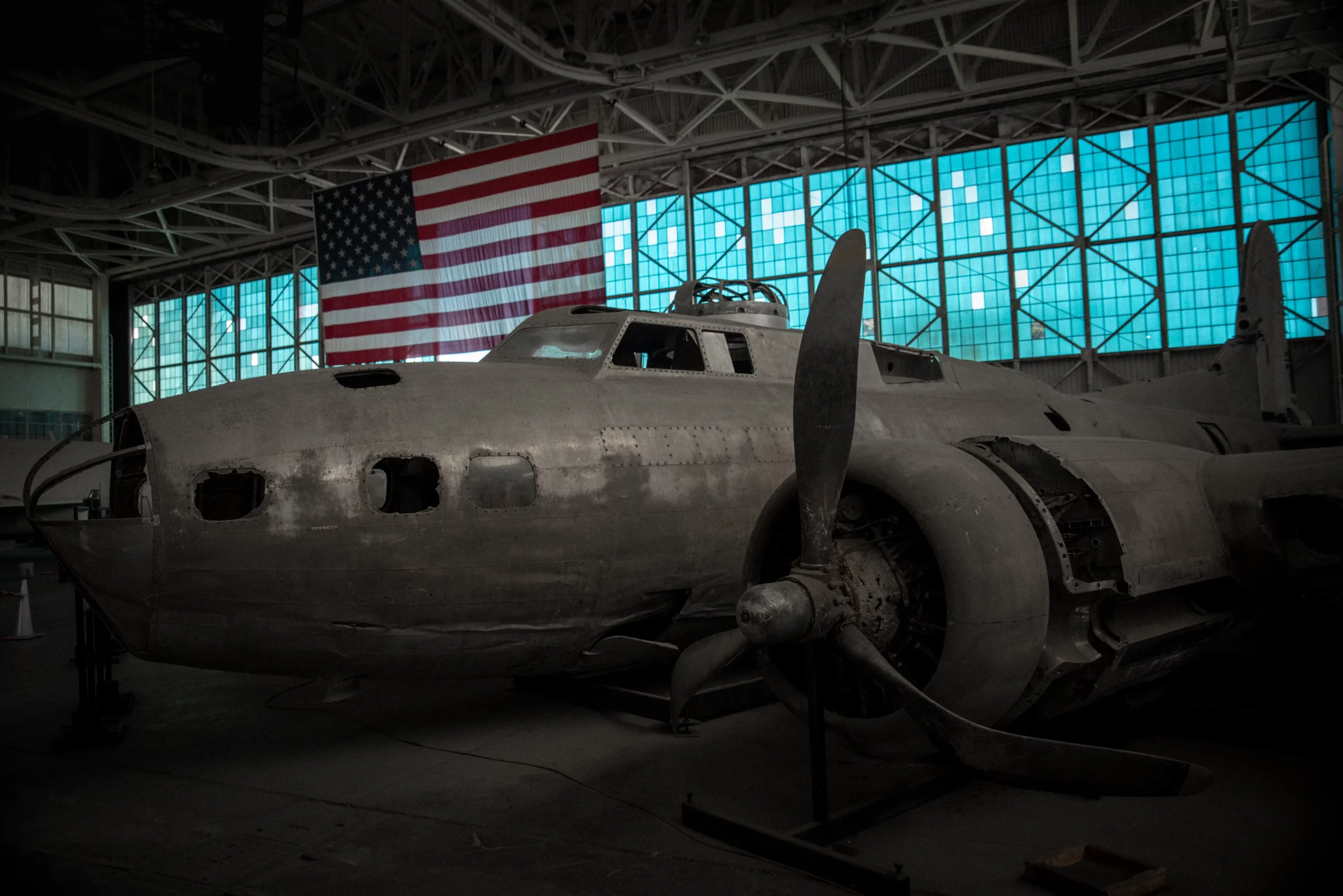 Old military plane in garage with flag